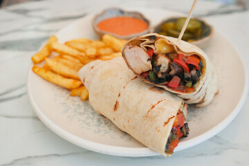 Delicious burrito with fries served at a local eatery
