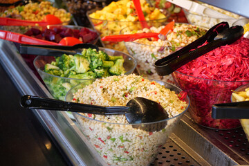 Fresh salads and colorful toppings at a salad bar buffet