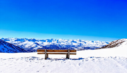Sturdy Wooden Bench on Hilltop Overlooking Snow-Capped Mountain Range in Winter
