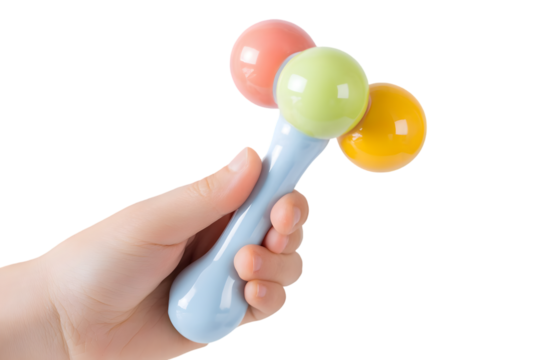 Colorful Baby Rattle Toy Held by a Child Hand against Black Background