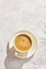 Espresso coffee cup with crema, bright lighting, overhead composition