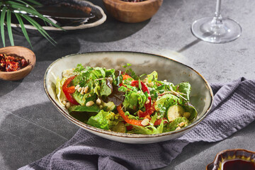 Green salad with bell pepper, zucchini, pine nuts, bright mood, overhead composition