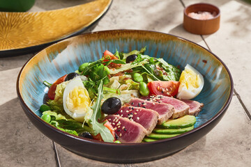 nicoise salad with seared medium tuna, bright natural light, overhead composition