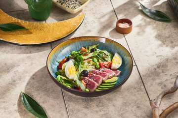 nicoise salad with medium-seared tuna, bright sunlight, overhead composition