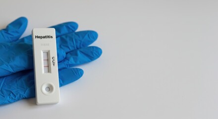 Hepatitis Rapid Diagnostic Test Kit on White Background with Blue Gloves