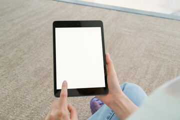 Hand holding digital tablet with blank screen for graphic display montage in the building area,...