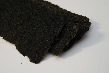 Stack of dried nori seaweed isolated on white background