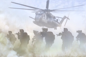 Military special force desert operation with transport helicopter in background