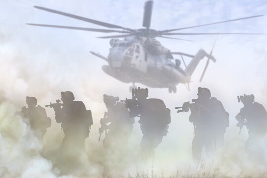 Military special force desert operation with transport helicopter in background