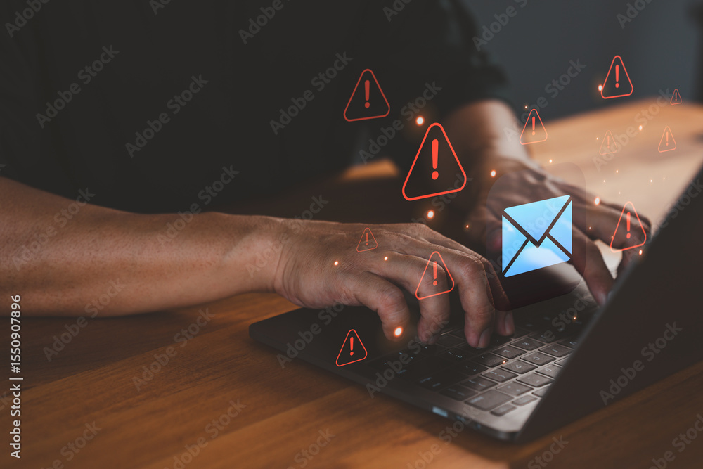 Poster person types on a laptop computer while warning email icons appear, symbolizing threats like phishin