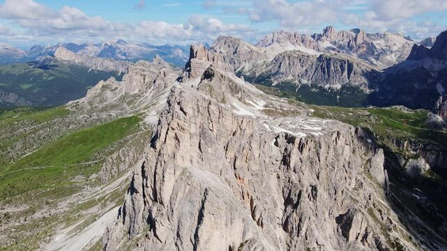 Cinematic aerial of Ra Gusela rock formation and alpine ridges in northern Italy