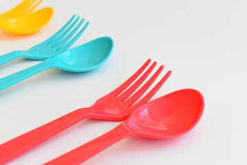 colorful spoon and fork isolated on white background, plastic cutlery for picnic