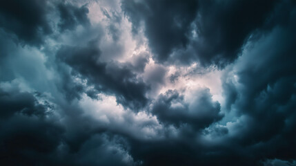 Obraz premium Dramatic storm clouds in deep blue, a sweeping skyscape with dynamic light, nature's raw power on display