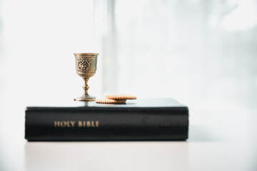 Christianity, holy communion ceremony is sacred act of worship and faith, where bread and wine in chalice symbolize body and blood of Christ in the religious eucharist tradition.