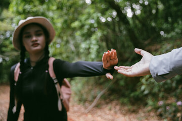 Two friends helping with teamwork trying to reach top of mountains during wonderful summer sunset. Teamwork couple hiking help each other trust assistance. Team of climbers two friends hiker.