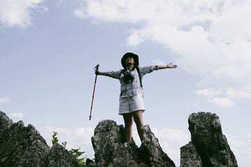 Woman hiker on top of mountain. Hiker with arms up on top of mountain successful young woman enjoying triumph. traveler exploring world. Hikers with backpacks relaxing. Sport and success concept.