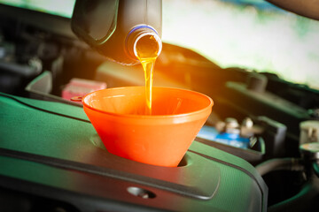 Refueling and pouring oil quality into the engine motor car Transmission and Maintenance Gear...