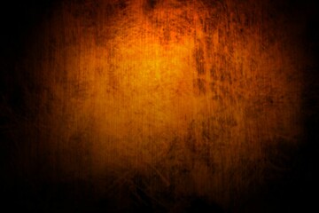 Abstract grunge texture is displaying mottled orange center fading to black edges, flat design