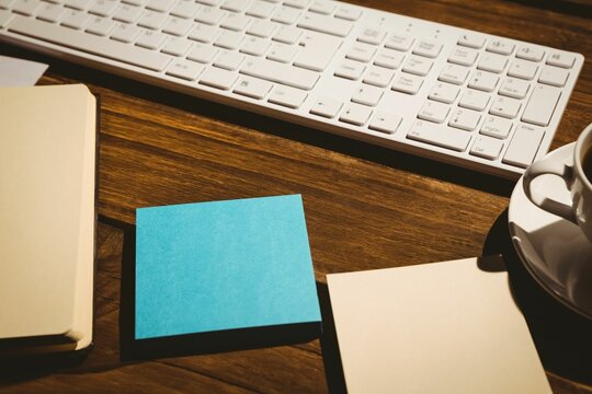 Fototapeta keyboard and coffee on table with papers