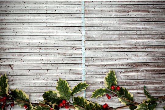 Holly twigs over wooden planks
