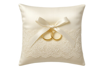 Two golden wedding rings are displayed on a satin pillow adorned with lace and tied with a ribbon, symbolizing a forthcoming marriage