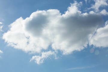 Flat design illustration is showing large fluffy cumulus cloud floating against bright blue sky