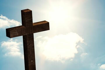 Wooden cross is standing in flat design composition, with sun shining through clouds and lens flare