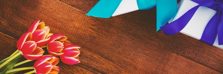 Fototapeta premium Flowers on wood floor with gifts