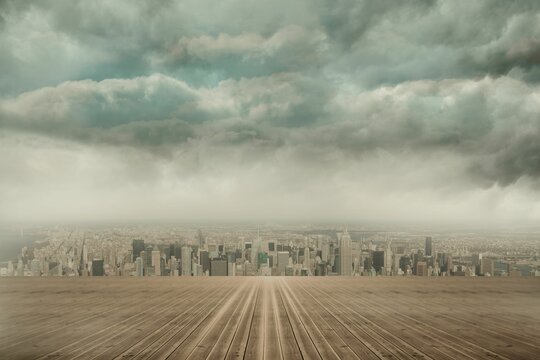 Fototapeta wooden deck platform is guiding gaze toward city skyline under looming storm clouds