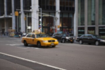 Yellow taxi cab is navigating busy urban street in flat design with black sedans, traffic lights