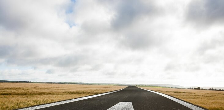 Fototapeta Flat design illustration is showing asphalt runway extending toward distant hills with grass fields