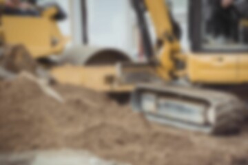 Bulldozer levelling mud at construction site
