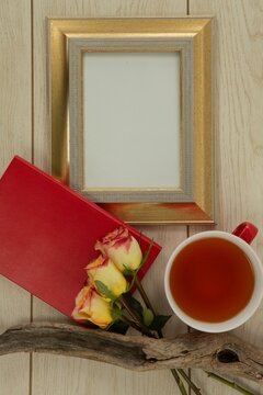 Fototapeta Photo frame, lemon tea and flowers on wooden table