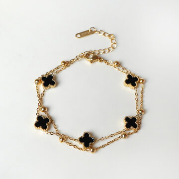 gold bracelet with thin chain and floral decoration