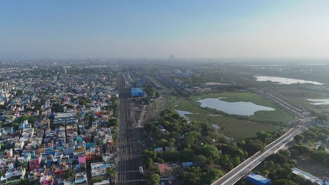 Top-down view of narrow streets and grid-like housing patterns located near railway station