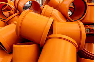 Orange pvc pipes stacked for plumbing or sewerage project