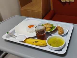Hospital food for patients, healthy meal with varied menu served on hospital bed.