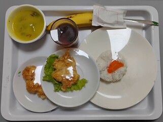 Hospital food for patients, healthy meal with varied menu served on hospital bed.