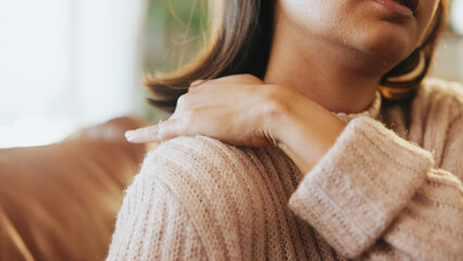 Woman, hands and shoulder pain of injury on sofa with inflammation, tender muscle and discomfort....