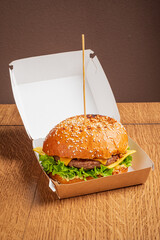 Succulent hamburger featuring cheddar cheese, crisp lettuce, and sesame seed bun, neatly presented