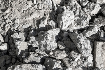 Pile of gray rocks and rubble in sunlight