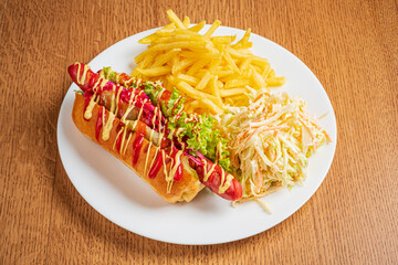 Enjoy a delicious hot dog with fresh toppings, served with crispy fries and coleslaw