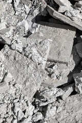 Pile of broken concrete rubble and debris in monochrome
