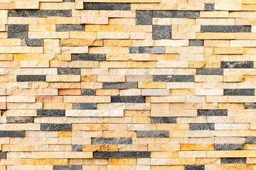 Multicolored brick wall texture pattern with stacked stone tiles