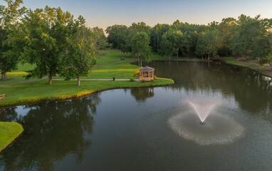 Aerial view of Fairview Park, Dublin, Georgia, USA, featuring a gazebo on a peninsula, a fountain...