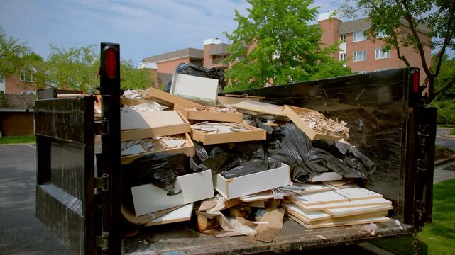 View of truck trailer full of garbage from construction site. Loaded truck view from inside