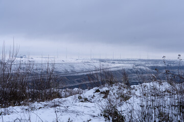 Snow-Covered Coal Mine Pit – Stark Contrast of Industry and Winter Landscape