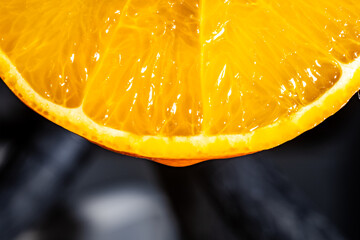 Detailed macro shot of a fresh orange slice showcasing vibrant textures and juiciness.