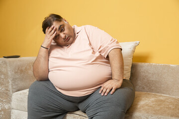 Stressed overweight indian man suffer with excess belly fat. Depressed Plus size guy have unable to...