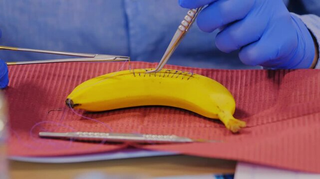 Medical trainees stitch banana surface in hands-on suturing skills session